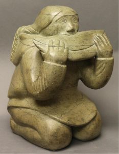 Unidentified Inuit Artist: KNEELING INUIT WOMAN SOFTENING A HIDE