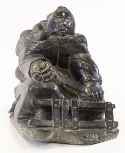 Makusi Pangutu Anauta: MOTHER WITH CHILD IN AMAUT, MENDING SLED